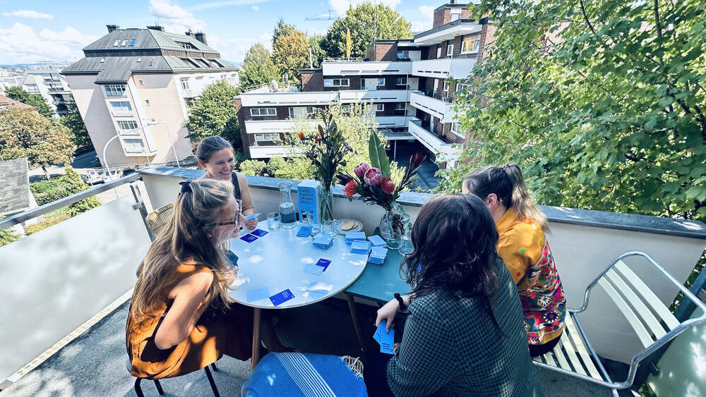Players around a table on a Zurich rooftop terrace